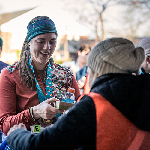 Volunteer handing out snacks